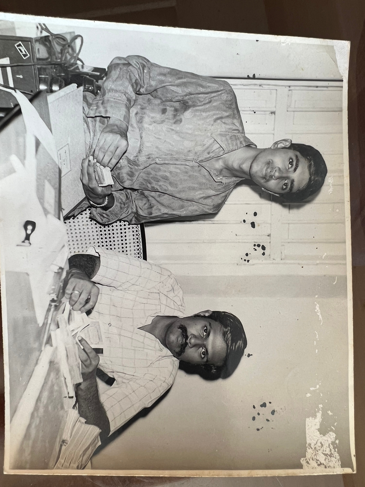 Ramki counting cash at the bank